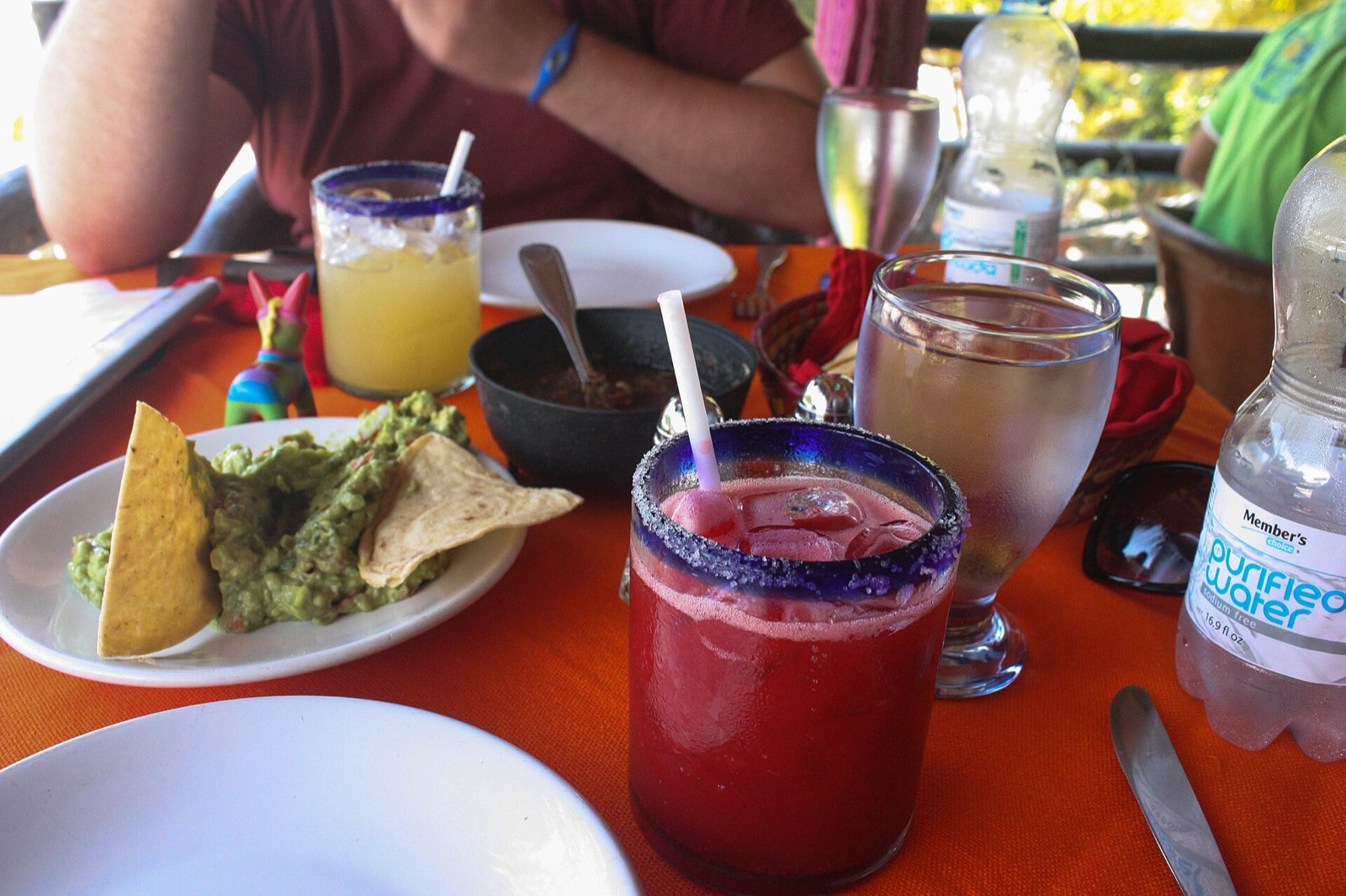Restaurant table in San José del Cabo with margaritas, guacamole, chips and a bottle of purified water
