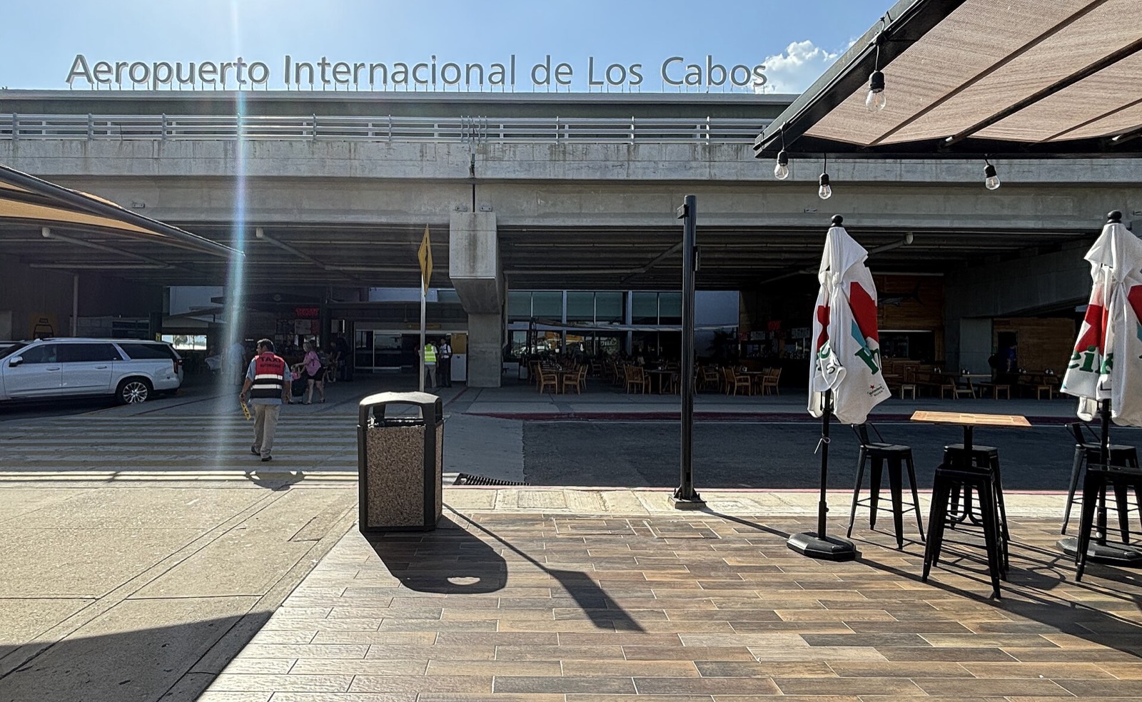 Main entrance of Los Cabos International Airport with its name sign above the terminal doors