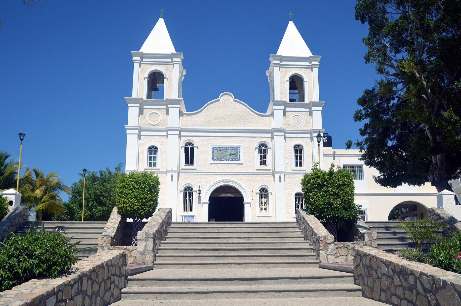 White twin-towered mission church above a stone staircase in the center of San José del Cabo