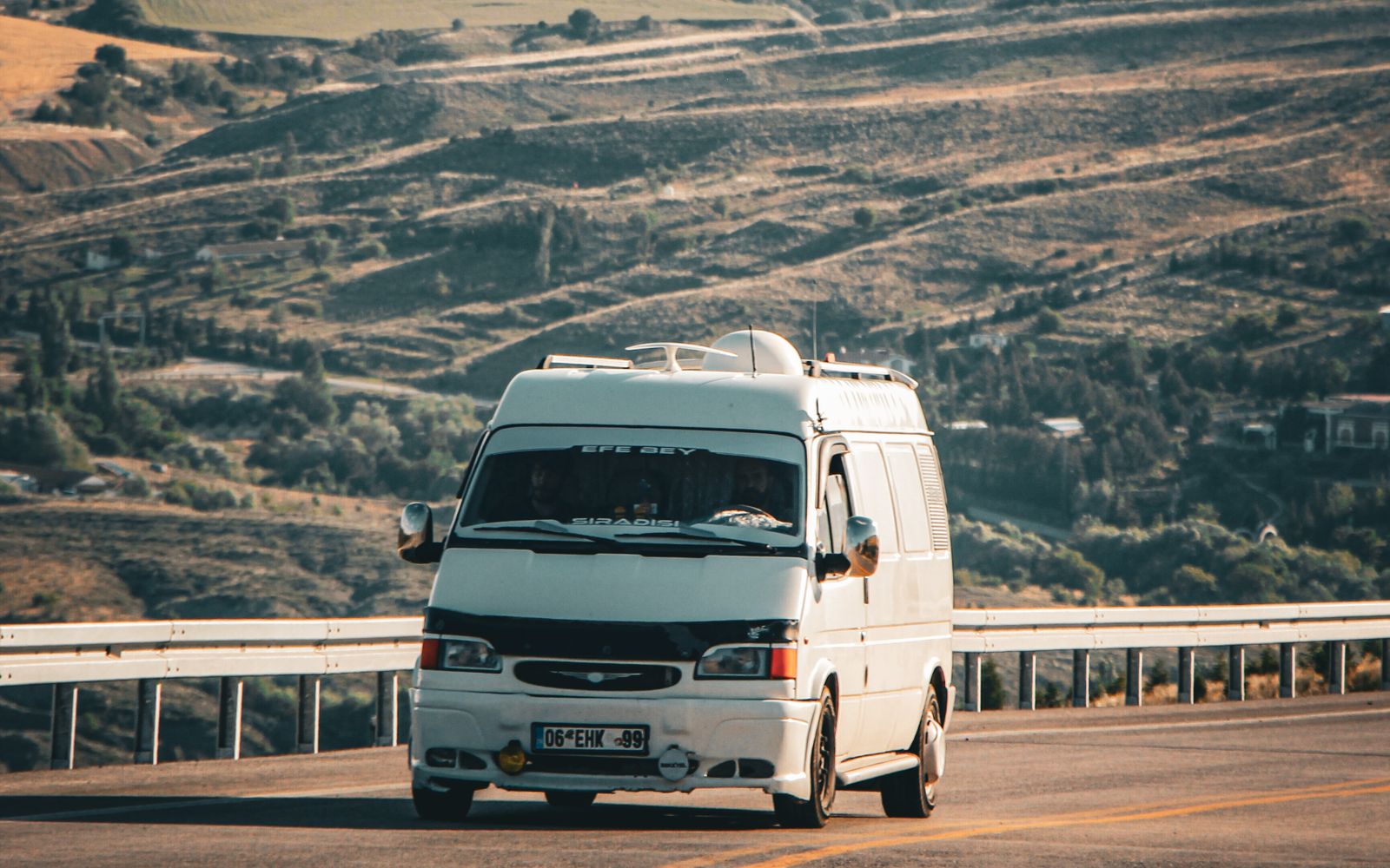 A shuttle van on a coastal highway